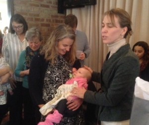 Pastor Jill praying for Maya (in Aunt Julie's arms) at baby shower