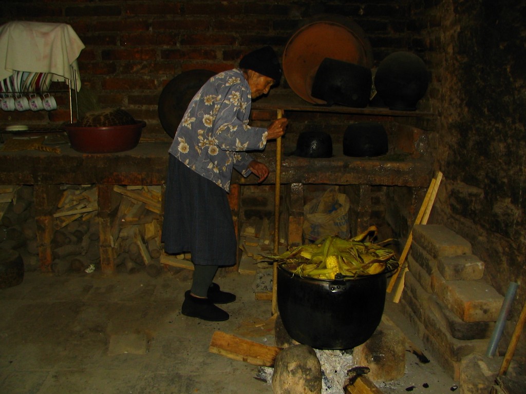 Fabian's grandmother who is over 100 years old cooking corn over a fire, the same way she has done her whole life