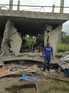 This is Edgar, one of the church leaders from Pedernales. The structure behind him is the second floor of his house and welding business. The first floor collapsed seconds after the ran out of the house.