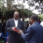 Rev Goma presenting the Bible to REv Kongo