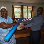 VP Vungbo giving new supplies to Mama Weka