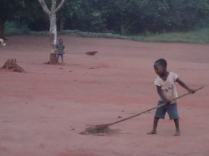 Little boy sweeping early in AM
