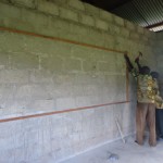 Ndekote putting up lathes around blackboard [640×480]