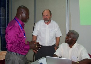 Simon Kamau (Kenya) and Curt Peterson (Cov World Mission) talking with Dennis Tongoi