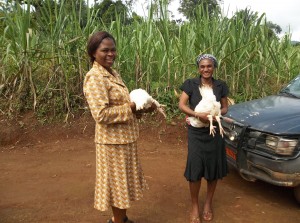 Two women holding the chickens they rasied from 3 weeks old