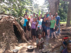 Drama Evangelism Team by a traditional pygmy house.
