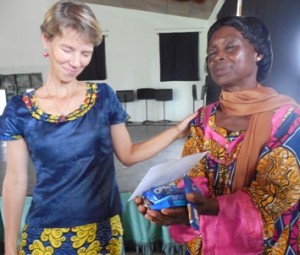 Mama Pauline with her friend Bianca, give thanks for the first gifts donated after chapel.