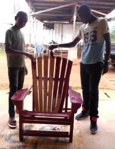 Donovan & Winner finish painting their chair red the last day of class.