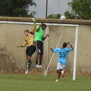 Goal keeper Nate and defender James jump to block a goal