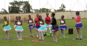 Cheerleaders in tutus with hula hoops