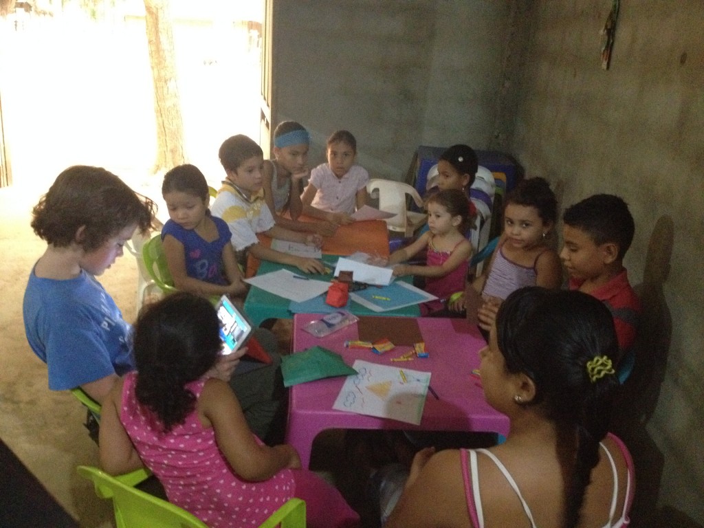 Teaching children origami in El Hato